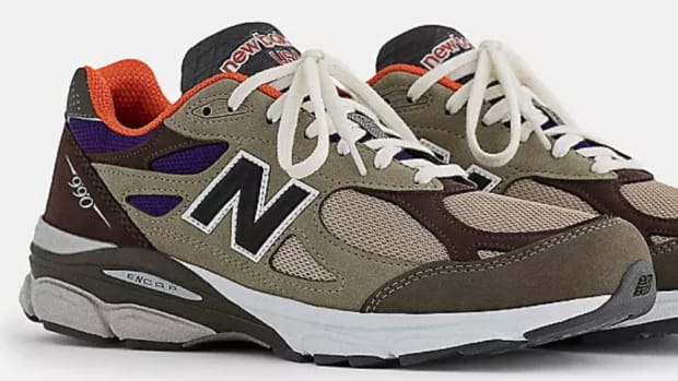 View of brown and orange New Balance shoes.